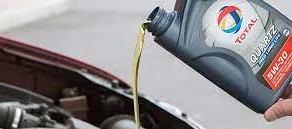 Lubricant being poured into a car engine